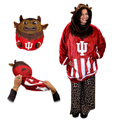 A person wearing a plush red and white Indiana University Bison mascot themed hooded costume with leopard-print pants, shown alongside close-up views of the hood and a matching plush pillow against a white background.